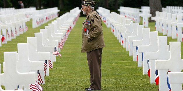 COLLEVILLE-SUR-MER, FRANCE - JUNE 05: World War II veteran William Spriggs, 89, of the 83rd Infantry Division and who took part in the invasion of Normandy, searches for fallen comrades in the Normandy American Cemetery June 5, 2014 in Colleville-sur-Mer, France. June 6th is the 70th anniversary of the D-Day landings which saw 156,000 troops from the allied countries including the United States and the United Kingdom join forces to launch an attack on the beaches of Normandy, these assaults are credited with the eventual defeat of Nazi Germany. A series of events commemorating the 70th anniversary is planned for the week with many heads of state travelling to the famous beaches to pay their respects to those who lost their lives. (Photo by Win McNamee/Getty Images)
