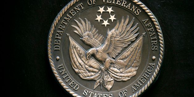 The U.S. Department of Veterans Affairs (VA) seal hangs on the facade at the headquarters in Washington, D.C., U.S., on Friday, May 10, 2013. The department's funding has jumped more than 40 percent to about $140 billion this year, compared with fiscal 2009, a boost to help the agency cope with a surge of new veterans returning home from the wars in Iraq and Afghanistan. Photographer: Andrew Harrer/Bloomberg via Getty Images