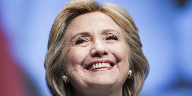 Former Secretary of State Hillary Clinton smiles before speaking at the World Bank May 14, 2014 in Washington, DC. Clinton an