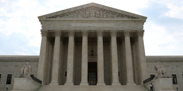 WASHINGTON, DC - JUNE 09: A guard stands outside the U.S. Supreme Court on June 9, 2014 in Washington, DC. The high court ruled today by 7 to 2 margin that homeowners in North Carolina can not sue a company that contaminated their drinking water because a state deadline has passed. A North Carolina state law strictly prohibits any lawsuit brought more than 10 years after the contamination even if residents did not realize their water was polluted until years later. (Photo by Mark Wilson/Getty Images)