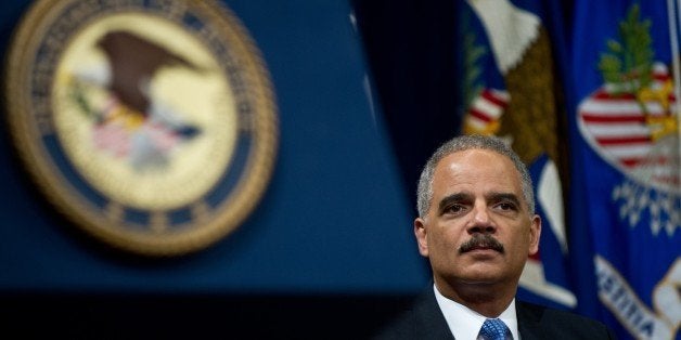 US Attorney General Eric Holder waits to address the Justice Department's Lesbian, Gay, Bisexual and Transgender (LGBT) Pride Month event at the Justice Department in Washington,DC on June 18, 2013. AFP PHOTO/Nicholas KAMM (Photo credit should read NICHOLAS KAMM/AFP/Getty Images)