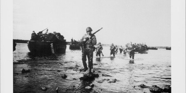 US soldiers advance towards land from the beaches at Normandy, D-Day, World War Two, France, June 6th 1944. (Photo by American Stock Archive/Archive Photos/Getty Images)
