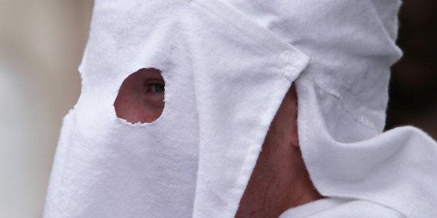 PULASKI, TN - JULY 11: A member of the Fraternal White Knights of the Ku Klux Klan participates in the 11th Annual Nathan Bedford Forrest Birthday march July 11, 2009 in Pulaski, Tennessee. With a poor economy and the first African-American president in office, there has been a rise in extremist activity in many parts of America. According to the Southern Poverty Law Center in 2008 the number of hate groups rose to 926, up 4 percent from 2007, and 54 percent since 2000. Nathan Bedford Forrest was a lieutenant general in the Confederate Army during the American Civil War and played a role in the postwar establishment of the first Ku Klux Klan organization opposing the reconstruction era in the South. (Photo by Spencer Platt/Getty Images)