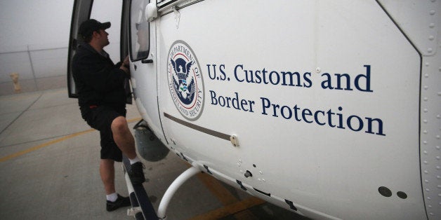 SAN DIEGO, CA - OCTOBER 01: A maintenance worker prepares a U.S. Office of Air and Marine (OAM) helicopter for takeoff to patrol the U.S.-Mexico border on October 1, 2013 in San Diego, California. OAM helicopters support the U.S. Border Patrol as well as Immigration and Customs Enforcement (ICE), personnel protecting border areas. While much of the Federal Government has closed down, personnel considered essential, such as border agents, remain working. (Photo by John Moore/Getty Images)