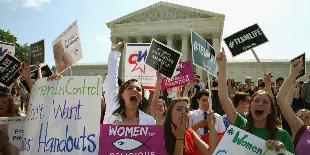 WASHINGTON, DC - JUNE 30: Hobby Lobby supporters react to the U.S. Supreme Court decision June 30, 2014 in Washington, DC. The high court ruled in a 5-4 decision in favor of Hobby Lobby saying that some private companies can be exempted, on religious grounds, from health care reform's requirement that employer sponsored health insurance policies cover contraception. (Photo by Mark Wilson/Getty Images)