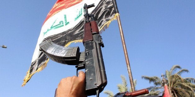 Iraqi tribesmen carry their weapons as they gather to show their willingness to join Iraqi security forces in the fight against Jihadist militants who have taken over several northern Iraqi cities, on June 16, 2014 in the southern city of Basra . Faced with a militant offensive sweeping south toward Baghdad, Prime Minister Nuri al-Maliki announced the Iraqi government would arm and equip civilians who volunteer to fight, and thousands have signed up. AFP PHOTO/STR (Photo credit should read STR/AFP/Getty Images)