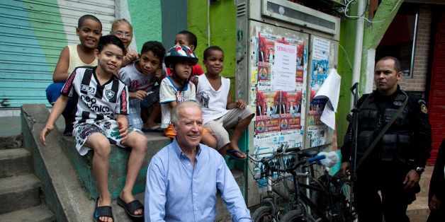 US Vice-President Joe Biden poses with children as he visits the Santa Marta slum in Rio de Janeiro, Brazil, on May 30, 2013. Biden arrived in Rio late Tuesday to push for closer energy cooperation with Latin America's dominant power and showcase Brazil as a strategic US partner. AFP PHOTO / POOL / Victor R. Caivano (Photo credit should read VICTOR R. CAIVANO/AFP/Getty Images)
