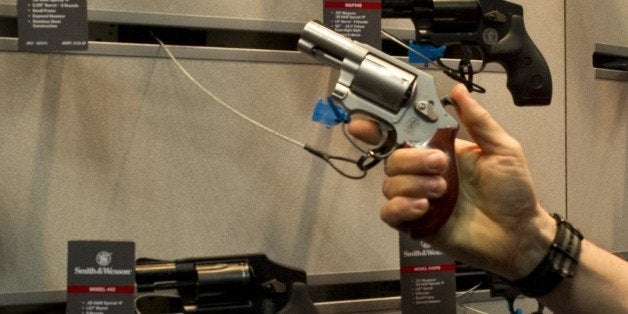 Convention goers look at the Smith & Wesson line of handguns at the 143rd NRA Annual Meetings and Exhibits at the Indiana Convention Center in Indianapolis, Indiana on April 26, 2014. Tens of thousands are converging on this city in the US heartland this weekend to celebrate American gun culture at the National Rifle Association's annual meeting, part political event and eye-catching display of weaponry. AFP PHOTO / Karen BLEIER (Photo credit should read KAREN BLEIER/AFP/Getty Images)