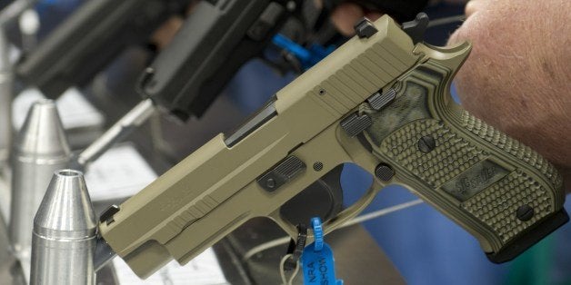 Semi-automatic handguns displayed at the143rd NRA Annual Meetings and Exhibits at the Indiana Convention Center in Indianapolis, Indiana on April 25, 2014. AFP PHOTO / Karen BLEIER (Photo credit should read KAREN BLEIER/AFP/Getty Images)