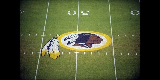 FILE - In this Aug. 28, 2009, file photo, the Washington Redskins logo is displayed at midfield before the start of a preseason NFL football game in Landover, Md. The team's nickname, which some consider a derogatory term for Native Americans, has faced a barrage of criticism. But a new Associated Press-GfK poll shows that nationally, âRedskinsâ still enjoys widespread support. (AP Photo/Nick Wass, File)