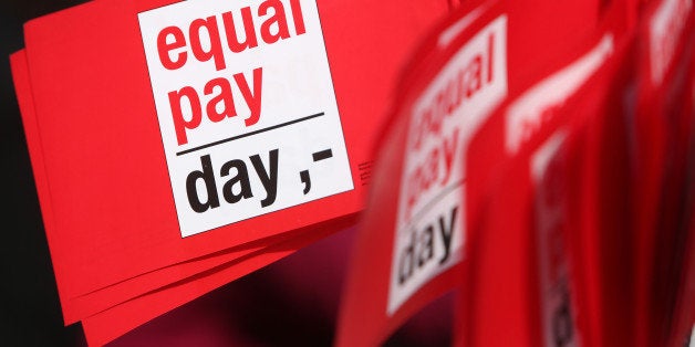 BERLIN, GERMANY - MARCH 21: Flags reading 'Equal Pay Day' are seen during the 'Equal Pay Day' demonstration on March 21, 2014 in Berlin, Germany. The annual event recognizes the wage gap between the sexes in the country, where women's salaries still lag behind that of men, particularly in the states that were once East Germany. (Photo by Adam Berry/Getty Images)