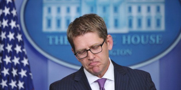 Outgoing White House Press Secretary Jay Carney pauses while speaking during his final press briefing in the Brady Briefing Room of the White House on June 18, 2014 in Washington, DC. AFP PHOTO/Mandel NGAN (Photo credit should read MANDEL NGAN/AFP/Getty Images)