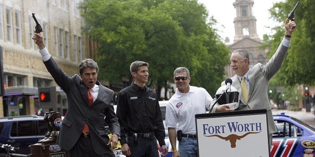 FORT WORTH, TX - APRIL 15: Texas Governor Rick Perry, left, and Fort Worth mayor Mike Moncrief, right, fire six-shooter pistols with NASCAR drivers Colin Braun and Bobby Labonte during an event on April 15, 2010 in Fort Worth, Texas. (Photo by Tom Pennington/Getty Images)