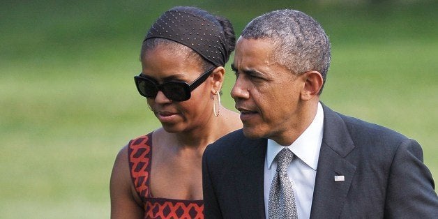 US President Barack Obama and First Lady Michelle Obama make their way across the South Lawn upon return to the White House on June 16, 2014 in Washington, DC. Obama returned to Washington from California. AFP PHOTO/Mandel NGAN (Photo credit should read MANDEL NGAN/AFP/Getty Images)