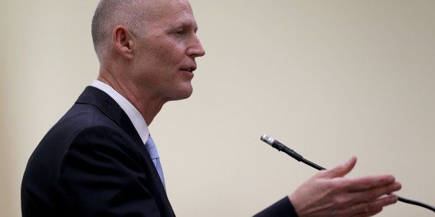 DAVIE, FL - MARCH 28: Florida Governor Rick Scott speaks as he attends the ribbon cutting for the opening of a I-595 Express Project on March 28, 2014 in Davie, Florida. The Governor finds himself dogged by questions about recent resignations by one of his top fundraisers, Mike Fernandez, as well as Gonzalo Sanabria, a longtime Miami-Dade Expressway Authority board member, who is reported to have resigned Thursday from his post to protest the disparaging and disrespectful treatment of Mike Fernandez, the former co-finance chairman of Gov. Rick Scotts campaign.' (Photo by Joe Raedle/Getty Images)