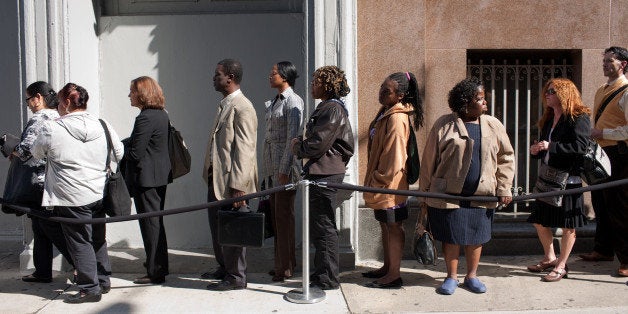 Job seekers wait on line outside the Metropolitan Pavilion before the start of a job fair in New York, U.S., on Sunday, Oct.