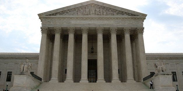 WASHINGTON, DC - JUNE 09: A guard stands outside the U.S. Supreme Court on June 9, 2014 in Washington, DC. The high court ruled today by 7 to 2 margin that homeowners in North Carolina can not sue a company that contaminated their drinking water because a state deadline has passed. A North Carolina state law strictly prohibits any lawsuit brought more than 10 years after the contamination even if residents did not realize their water was polluted until years later. (Photo by Mark Wilson/Getty Images)