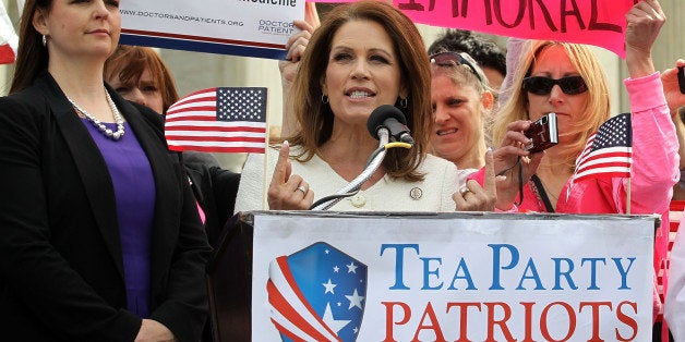 WASHINGTON, DC - MARCH 28: U.S. Rep. Michele Bachmann (R-MN) (2nd L) speaks as Tea Party Patriots national coordinator Jenny Beth Martin (L) listens on during a rally in front of the U.S. Supreme Court March 28, 2012 in Washington, DC. Today is the last of three day the high court set to hear arguments over the oral arguments on the Patient Protection and Affordable Care Act. (Photo by Alex Wong/Getty Images)