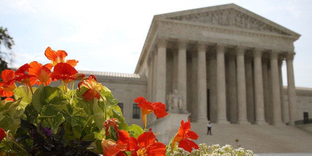 WASHINGTON, DC - JUNE 09: Flowers are bloom in front of the U.S. Supreme Court , on June 9, 2014 in Washington, DC. The high court ruled today by 7 to 2 margin that homeowners in North Carolina can not sue a company that contaminated their drinking water because a state deadline has passed. A North Carolina state law strictly prohibits any lawsuit brought more than 10 years after the contamination even if residents did not realize their water was polluted until years later. (Photo by Mark Wilson/Getty Images)