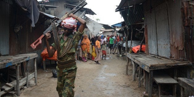 A Somalian soldier patrols at the Karan market, in Somalia's capital of Mogadishu on June 30, 2014 after a bomb exploded. Two