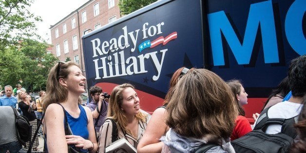 Supporters of former US Secretary of State Hillary Clinton wait as volunteers from Ready for Hillary hand out posters and bumper stickers after Clinton spoke about her new book 'Hard Choices' at the George Washington University in Washington on June 13, 2014. Clinton is widely thought to be mulling a run for the 2016 presidential election. AFP PHOTO/Nicholas KAMM (Photo credit should read NICHOLAS KAMM/AFP/Getty Images)