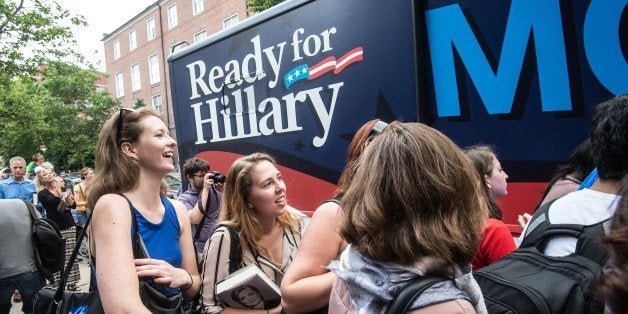 Supporters of former US Secretary of State Hillary Clinton wait as volunteers from Ready for Hillary hand out posters and bumper stickers after Clinton spoke about her new book 'Hard Choices' at the George Washington University in Washington on June 13, 2014. Clinton is widely thought to be mulling a run for the 2016 presidential election. AFP PHOTO/Nicholas KAMM (Photo credit should read NICHOLAS KAMM/AFP/Getty Images)