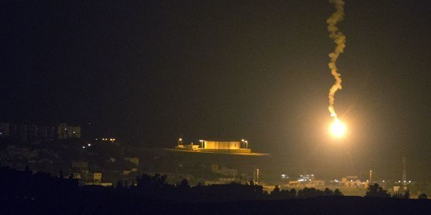 A picture taken from the southern Israeli border with the Gaza Strip shows Israeli flares illuminating the Palestinian coastal enclave, on July 7, 2014. Israeli air strikes on Gaza, that killed at least seven Palestinian militants overnight, came after a day in which armed groups fired at least 25 rockets and mortar rounds at southern Israel. The Gaza violence came as violence raged across annexed east Jerusalem and Arab towns in Israel following the kidnap and murder of a Palestinian teenager in a suspected revenge attack by Jewish extremists who burned him alive. AFP PHOTO / JACK GUEZ (Photo credit should read JACK GUEZ/AFP/Getty Images)