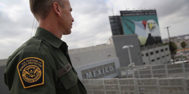 SAN YSIDRO, CA - OCTOBER 03: U.S. Border Patrol agent Jerry Conlin stands on the American side of the U.S.-Mexico border on