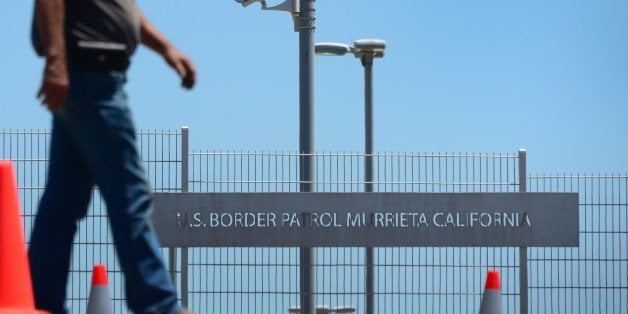 Anti-illegal immigration resident Burke (no last name given) patrols outside the US Border Patrol facility in Murrieta, Calif