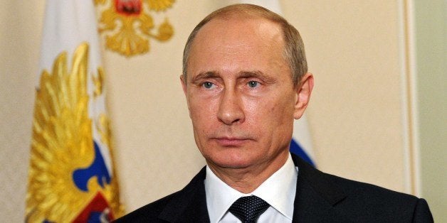 Russia's President Vladimir Putin looks on in the Novo-Ogaryovo residence outside Moscow, early on July 21, 2014, while recording his video address on the Malaysia Airlines crash. In his overnight video address shown today in the early hours Putin said that the Malaysia Airlines crash should not be used for 'political ends' and international experts given access to the crash site, without announcing specific steps by Moscow. AFP PHOTO / RIA-NOVOSTI / POOL/ MIKHAIL KLIMENTYEV (Photo credit should read MIKHAIL KLIMENTYEV/AFP/Getty Images)