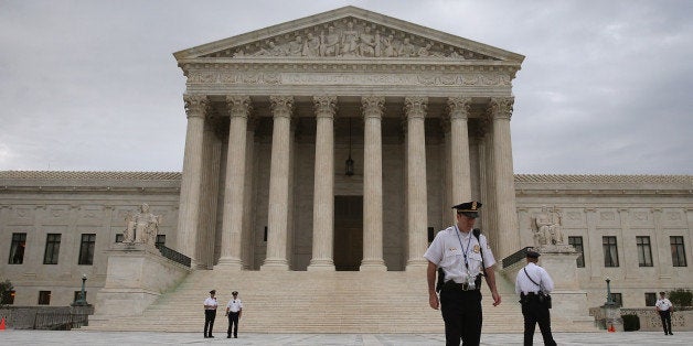 WASHINGTON, DC - JUNE 30: Police stand in front of the U.S. Supreme Court on June 30, 2014 in Washington, DC. Today the high