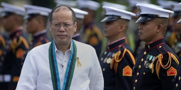 Philippine President Benigno Aquino (L) inspects a line up of honour guards during a change of command ceremony at the Armed Forces of the Philippines (AFP) headquarters in Manila on July 18, 2014. Outgoing chief of staff of the AFP, General Emmanuel Bautista, will turn over his position to incoming AFP chief of staff General Gregorio Pio Catapang. AFP PHOTO / NOEL CELIS (Photo credit should read NOEL CELIS/AFP/Getty Images)