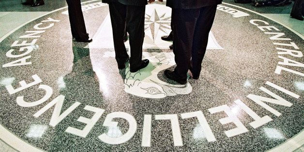 386984 06: President George W. Bush, Central Intelligence Agency Director George Tenet and others stand on the seal of the Agency March 20, 2001 at the CIA Headquarters in Langley, Virginia. Bush toured the facility and met some of the Agency''s employees. (Pool Photo by David Burnett/Newsmakers)