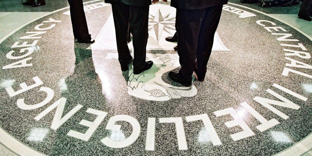386984 06: President George W. Bush, Central Intelligence Agency Director George Tenet and others stand on the seal of the Ag