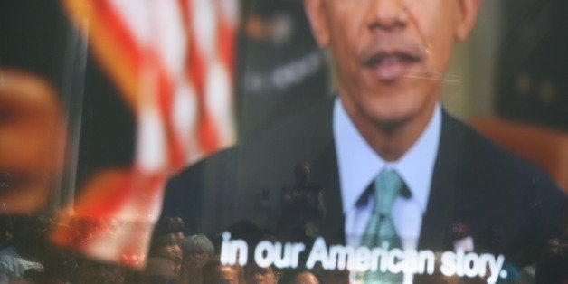 NEW YORK, NY - JULY 22: New American citizens watch a presentation by President Obama following a special naturalization cer
