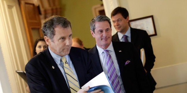 WASHINGTON, DC - APRIL 24: Sen. Sherrod Brown (D-OH) (L) and Sen. David Vitter (R-LA) (R) arrive for a press conference announcing the details of 'Too Big to Fail' legislation at the U.S. Capitol April 24, 2013 in Washington, DC. The legislation would include capital requirements for financial institutions to protect against losses and prevent the use of federal funds to bail them out should they fail. (Photo by Win McNamee/Getty Images)