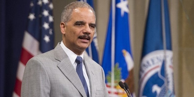 US Attorney General Eric Holder speaks during a Naturalization Ceremony at the Justice Department in Washington, DC, July 22, 2014. Seventy people from around the world were sworn in as new US citizens during the ceremony. AFP PHOTO / Saul LOEB (Photo credit should read SAUL LOEB/AFP/Getty Images)