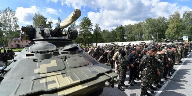 New volunteer recruits of the Ukrainian army 'Donbass' battalion take part in a military oath ceremony of the National Guard near the Novi Petrivtsi village not far from Kiev, on June 23, 2014. Some 600 new volunteer recruits of the battalion, mainly representatives of the eastern Donbass region of Ukraine, who followed combat training during three weeks will take part in the military operation against armed pro-Russian militants in the east of the country. Ukraine pressed German Chancellor Angela Merkel and other Western allies today to help end a pro-Russian uprising that has continued to rage in the industrial east despite Kiev's unilateral ceasefire. AFP PHOTO / SERGEI SUPINSKY (Photo credit should read SERGEI SUPINSKY/AFP/Getty Images)