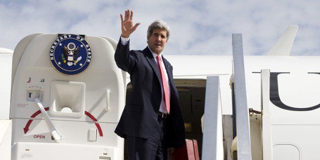 US Secretary of State John Kerry waves as he boards a plane while leaving Ben Gurion Airport after a meeting with Israeli Prime Minister on April 1, 2014. Kerry met Israel's Benjamin Netanyahu for the second time in 12 hours, as sources said a jailed US-Israeli spy could be key to saving troubled peace talks. AFP PHOTO / POOL / JACQUELYN MARTIN (Photo credit should read JACQUELYN MARTIN/AFP/Getty Images)