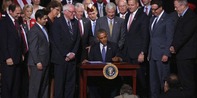 FORT BELVOIR, VA - AUGUST 07: U.S. President Barack Obama participates in a signing ceremony for H.R. 3230 as (L-R) Secretary of Veterans Affairs Robert McDonald, Rep. Raul Ruiz (D-CA), Rep. Jackie Walorski (R-IN), Sen. Bernie Sanders (I-VT), House Minority Whip Rep. Steny Hoyer (D-MD), Rep. Michael Michaud (D-ME), Rep. Jeff Denham (R-CA), Rep. Pete Gallego (D-TX) and Rep. Morgan Griffith (R-VA) look on August 7, 2014 at Wallace Theater in Fort Belvoir, Virginia. President Obama has signed the Veterans' Access to Care through Choice, Accountability, and Transparency Act of 2014 into law. (Photo by Alex Wong/Getty Images)