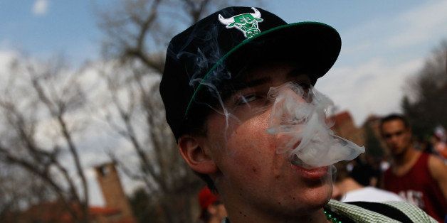 BOULDER, CO - APRIL 20: A student smokes a marijuana cigarette during a 'smoke out' with thousands of others April 20, 2010 at the University of Colorado in Boulder, Colorado. April 20th has become a de facto holiday for marijuana advocates, with large gatherings and 'smoke outs' in many parts of the United States. Colorado, one of 14 states to allow use of medical marijuana, has experienced an explosion in marijuana dispensaries, trade shows and related businesses in the last year as marijuana use becomes more mainstream here. (Photo by Chris Hondros/Getty Images)