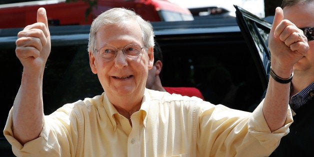 FANCY FARM, KY - AUGUST 02: Senate Minority Leader Mitch McConnell (R-KY) signals to supporters as he arrives at the Fancy Farm picnic August 2, 2014 in Fancy Farm, Kentucky. With today's annual Fancy Farm picnic, a Kentucky political tradition, recent polls show McConnell and the Democratic nominee, Kentucky Secretary of State Alison Grimes in a virtual tie. (Photo by Win McNamee/Getty Images)