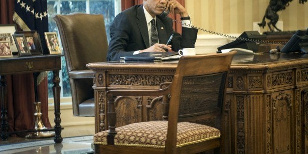 US President Barack Obama speaks on the phone with King Abdullah II of Jordan in the Oval Office of the White House on August 8, 2014 in Washington, DC. US jets struck jihadist positions in northern Iraq on Friday, a potential turning point in a two-month crisis Washington said was threatening to result in genocide and to expose US assets. President Barack Obama's order for the first air strikes on Iraq since he put an end to US occupation in 2011 came after Islamic State (IS) militants made massive gains on the ground, seizing a dam and forcing a mass exodus of religious minorities. AFP PHOTO/Brendan SMIALOWSKI (Photo credit should read BRENDAN SMIALOWSKI/AFP/Getty Images)