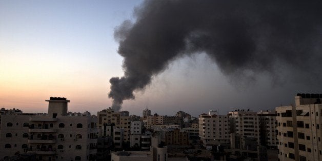 Smoke raises over Gaza City after an Israeli airstrike in Gaza city on August 10, 2014. Israel and the Palestinians agreed to