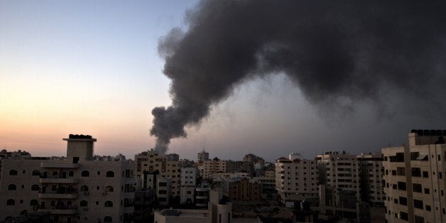 Smoke raises over Gaza City after an Israeli airstrike in Gaza city on August 10, 2014. Israel and the Palestinians agreed to a fresh 72-hour ceasefire in Gaza, accepting an Egyptian invitation to resume talks to end fighting that has killed more than 2,000 people. AFP PHOTO / MAHMUD HAMS (Photo credit should read MAHMUD HAMS/AFP/Getty Images)