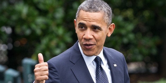 US President Barack Obama gives the thumbs up as he walks out of the White House in Washington on October...