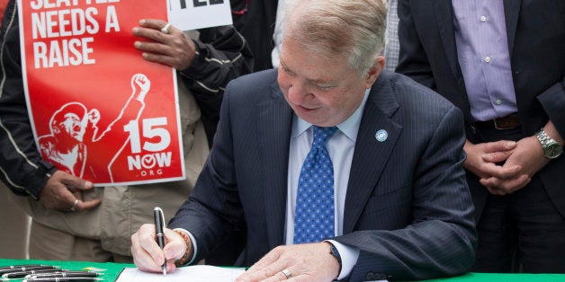 SEATTLE, WA - JUNE 3: Seattle Mayor Ed Murray signs a bill that raises the city's minimum wage to $15 an hour on June 3, 2014 in Seattle, Washington. The bill passed unanimously in a June 2 Seattle city council meeting. (Photo by David Ryder/Getty Images)