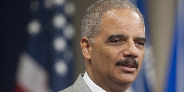 US Attorney General Eric Holder speaks during a Naturalization Ceremony at the Justice Department in Washington, DC, July 22, 2014. Seventy people from around the world were sworn in as new US citizens during the ceremony. AFP PHOTO / Saul LOEB (Photo credit should read SAUL LOEB/AFP/Getty Images)