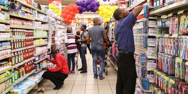 Employees restock shelves with pharmaceutical products inside a Shoprite Holdings Ltd. supermarket in Johannesburg, South Africa, on Thursday, Aug. 14, 2014. Shoprite is South Africa's biggest food retailer and earns about one sixth of its revenue outside of the country. Photographer: Dean Hutton/Bloomberg via Getty Images