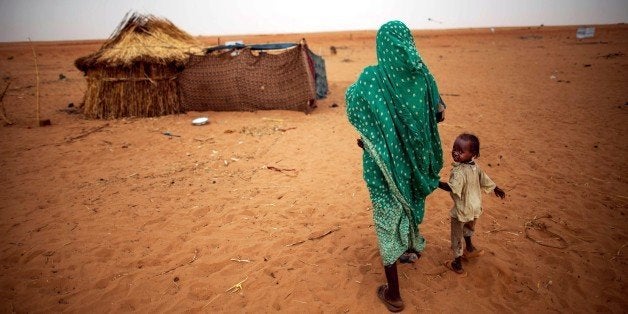 DARFUR, SUDAN - JUNE 11: Sudanese shelter in refugee camps in their shelter in a new settlement at Zam Zam camp for Internally Displaced People (IDP) in North Darfur, Sudan on June 11, 2014. Thousands of people, mostly women, children and elderly, search for shelter in the Zam Zam refugee camp following an armed militia attack on their villages. Many of the recently displaced hail from different villages around Tawila, Korma and Tina in North Darfur as well as Khor Abeche in South Darfur. The displaced community continues to request for basic services such as water, food, healthcare services and shelter for refugees. (Photo by Pool-UNAMID/Anadolu Agency/Getty Images)